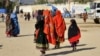 Afghan refugees arrive from Pakistan at the border in the Spin Boldak district of Kandahar Province on December 3.