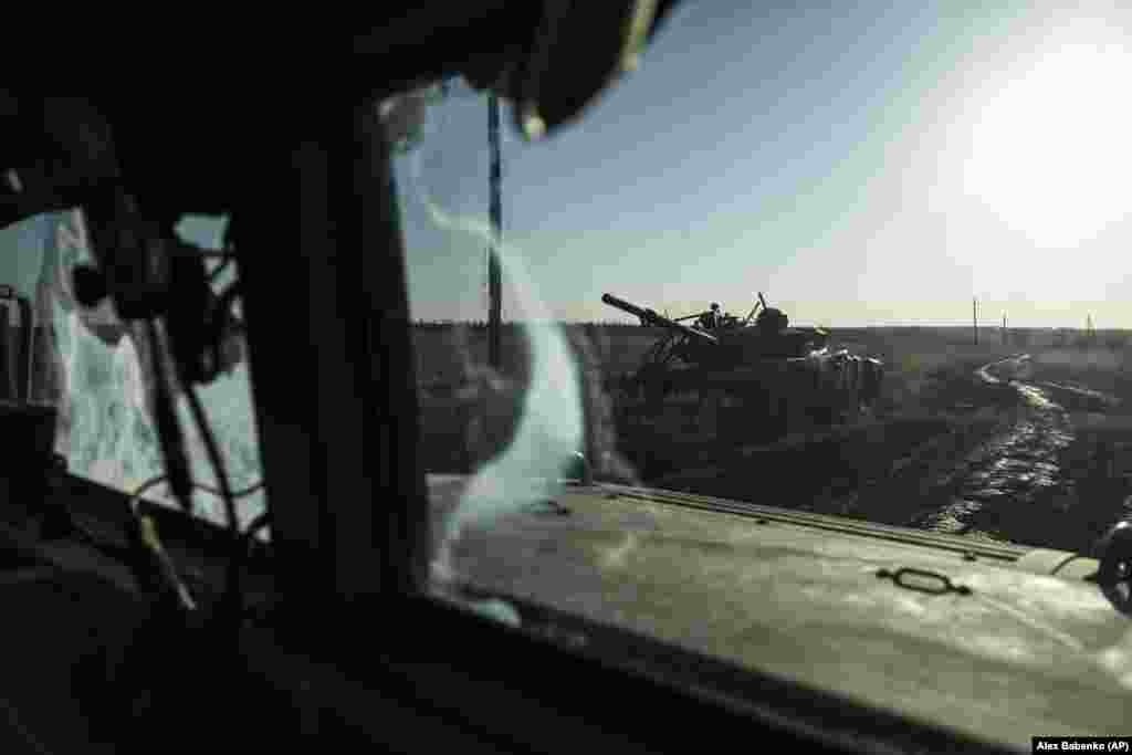 A destroyed tank is seen from the window of an armored vehicle at the front line near Klishchiyivka in eastern Ukraine.