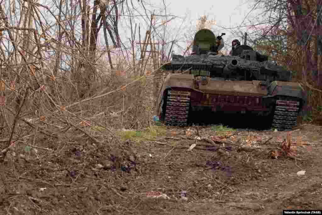 A Russian T-90MS tank emerging from broken trees in Bakhmut on April 10. On the Russian side of the battle for Bakhmut, access is effectively impossible for reporters not directly employed by the Kremlin or championing the Russian invasion. This photo was made by Valentin Sprinchak, a photographer with Russia&rsquo;s TASS news agency.