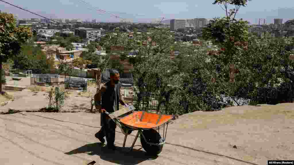 Baba Karim pushes his wheelbarrow in Kabul on September 3. The 45-year-old is one of the estimated 36 million Afghans -- around 90 percent of the population -- who are in need of food assistance. &nbsp;