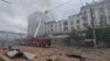 Firefighters work at a site of an apartment building hit by a Russian missile strike in Dnipro on April 19.