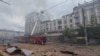 Firefighters work at a site of an apartment building hit by a Russian missile strike in Dnipro on April 19.