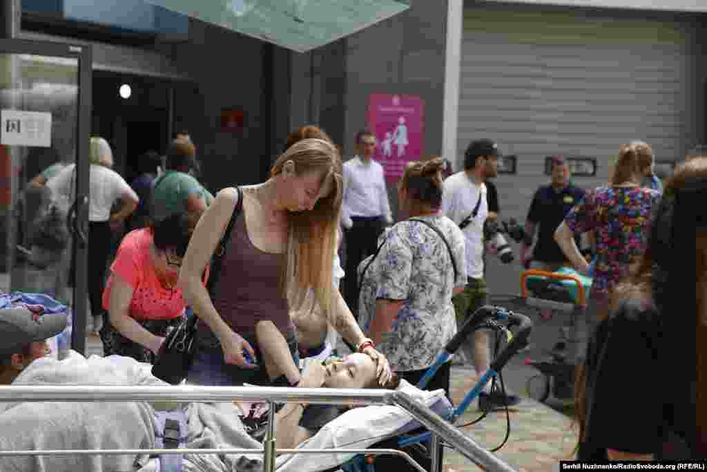 A woman comforts a child outside the damaged hospital. It was not immediately clear if there were fatalities at the site. &nbsp;