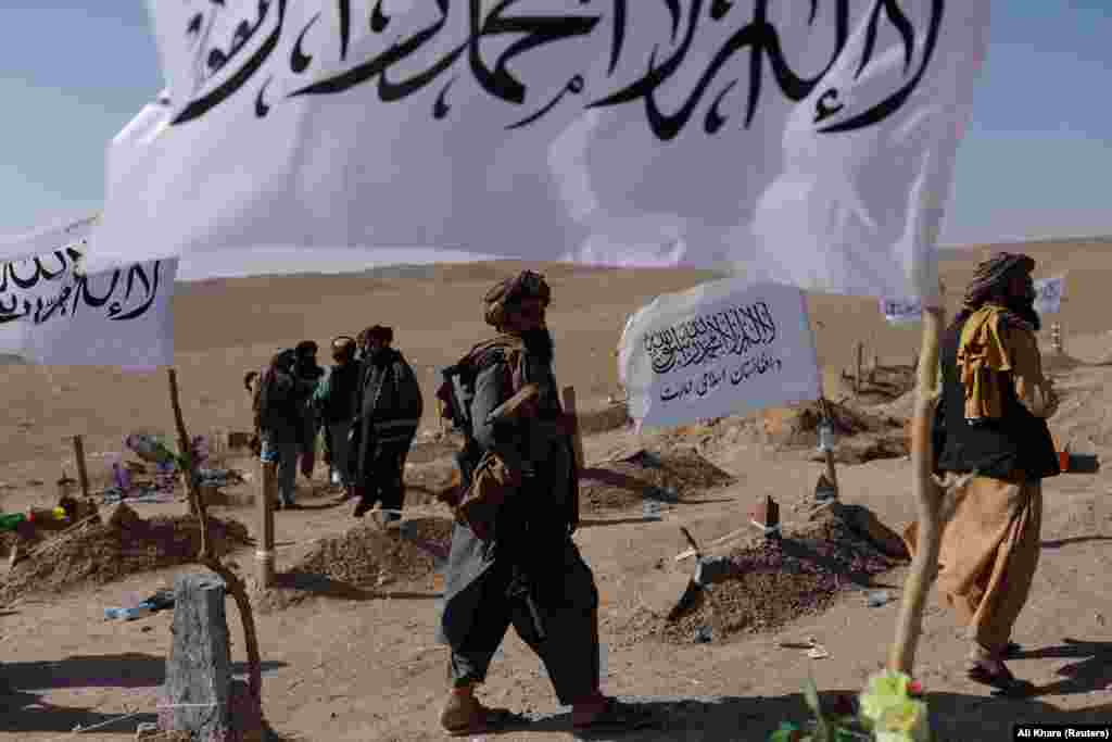 Taliban soldiers walk through a cemetery for victims of the recent earthquake.&nbsp; Neighboring Pakistan has offered assistance but officials in Islamabad said&nbsp;the delivery of its humanitarian aid has been on hold since October 9 as they wait for &ldquo;clearance&rdquo; from the Taliban.