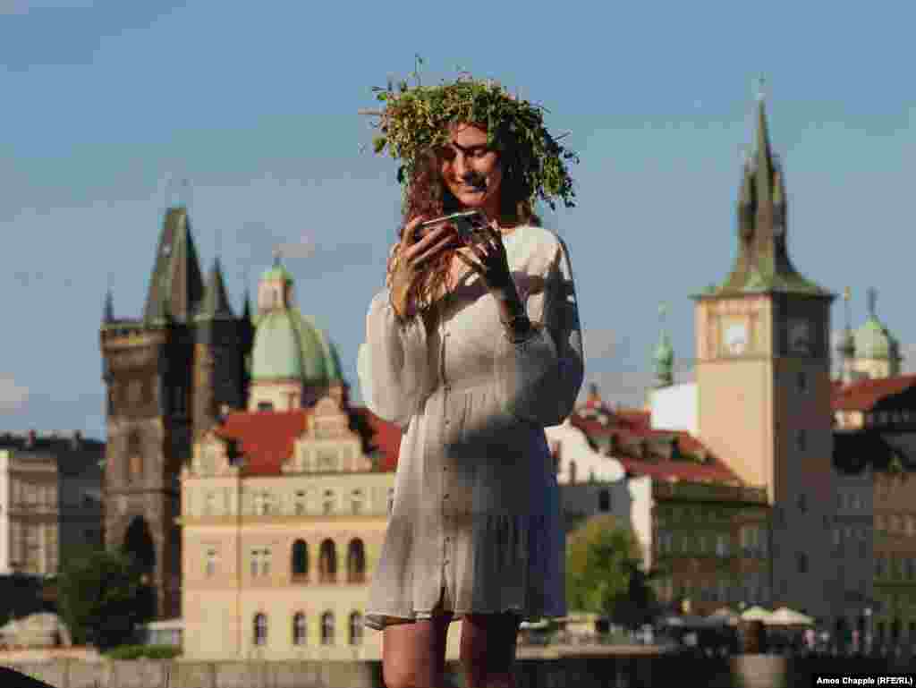 Kamila checks a selfie she made in front of the Prague skyline. Kamila fled the 2022 invasion and moved to Slovakia with her family before settling in Prague. &quot;I miss most the fields,&rdquo; she said of her native region of Donetsk. &quot;On nights like this I loved going out into the fields to have picnics and just enjoy nature, but I love Prague too.&quot; &nbsp;