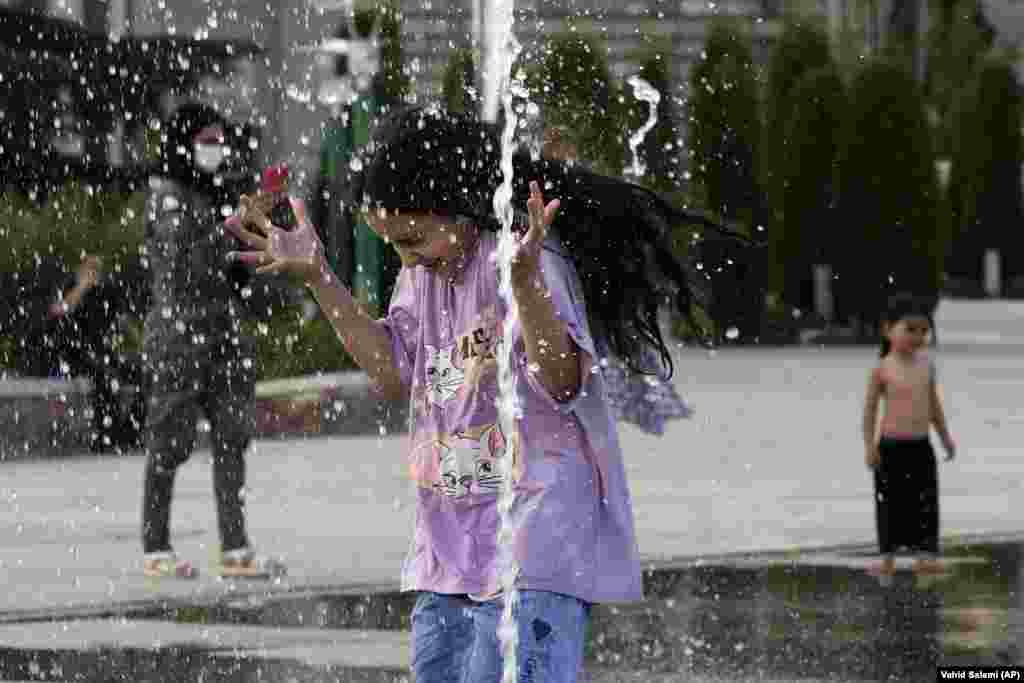 A young girl cools off in a water fountain at Tehran&#39;s Ebrahim Park as temperatures reached 38 degrees Celsius on August 1. State media reported temperatures had this week exceeded 51 degrees Celsius in the southern city of Ahvaz.&nbsp;
