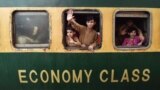 Children wave from a train as they prepare to travel to their homes to celebrate Eid al-Fitr in Karachi, Pakistan. Eid al-Fitr is an Islamic holiday that marks the end of Ramadan.