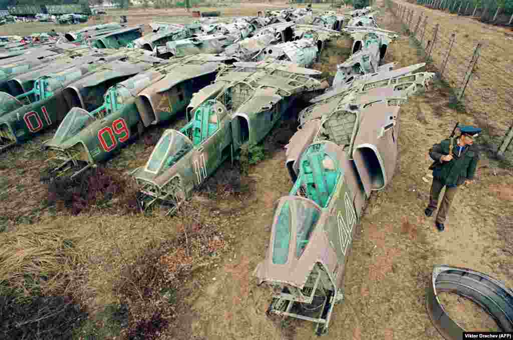 A soldier is seen alongside scrapped fighter jets at a military base in the Brest region of western Belarus. Independent Belarus inherited arms-reduction obligations that were initially agreed between the Soviet Union and the United States. Minsk removed and destroyed all of its nuclear weapons infrastructure. Some 3,000 Belarusian tanks and armored vehicles and 130 military aircraft were also destroyed through the 1990s as part of the Western-backed demilitarization process.