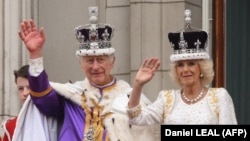 Britain's King Charles III and Britain's Queen Camilla wave from the Buckingham Palace balcony after their coronation on May 6. 