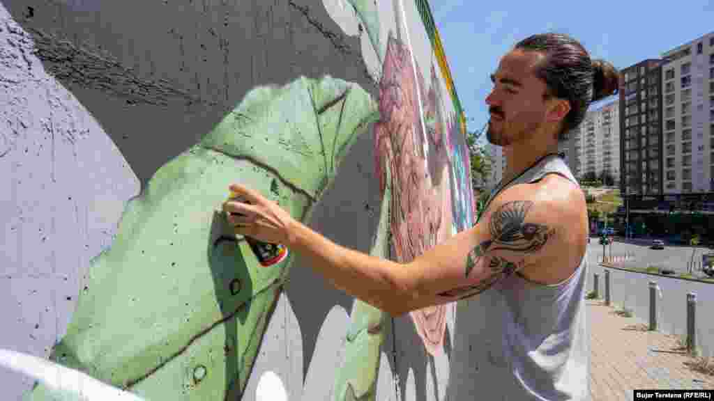 Italian graffiti artist Mattia Martini at work. &quot;I painted a whale. It is made as if it were a tree.&nbsp;So there are leaves and branches that grow like a tree.&nbsp;So the whale is flying, like in a fantastic universe,&quot; Martini said.
