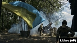 Ukrainian soldiers fire a cannon near Bakhmut, an eastern city where fierce battles against Russian forces have been taking place, in the Donetsk region on May 12.