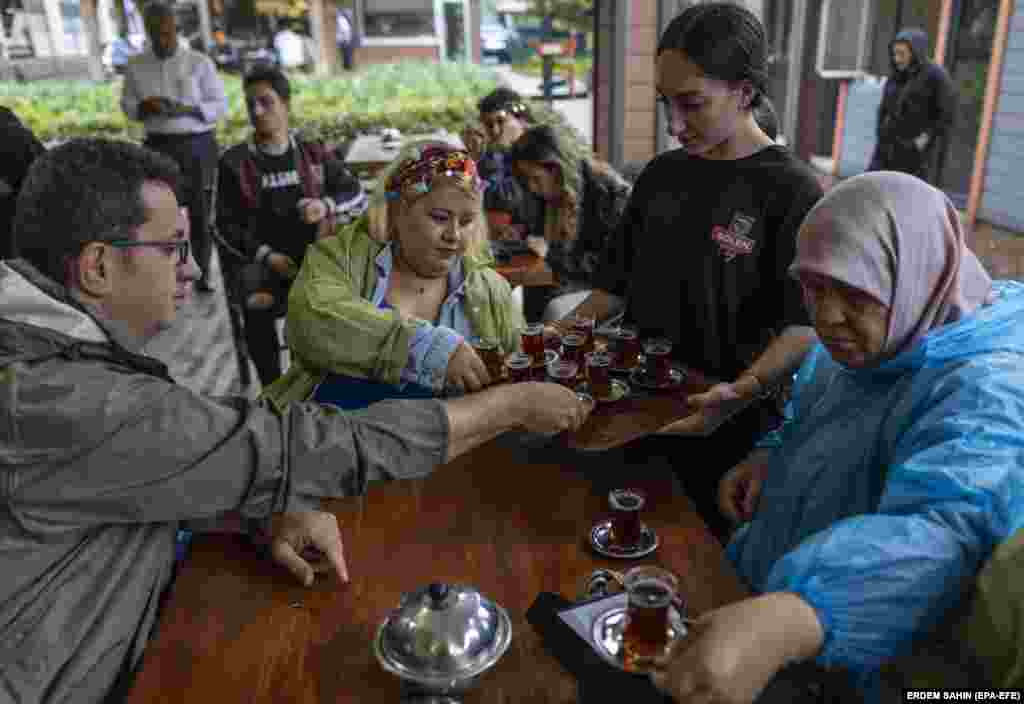 Domestic tourists are served tea during their visit to a tea plantation in Trabzon. With a&nbsp;cost-of-living crisis, dwindling foreign reserves, and the lira reaching record lows, Ankara has been pushing tens of thousands of Afghans back at its land border with Iran or deporting them directly to Afghanistan. &nbsp;