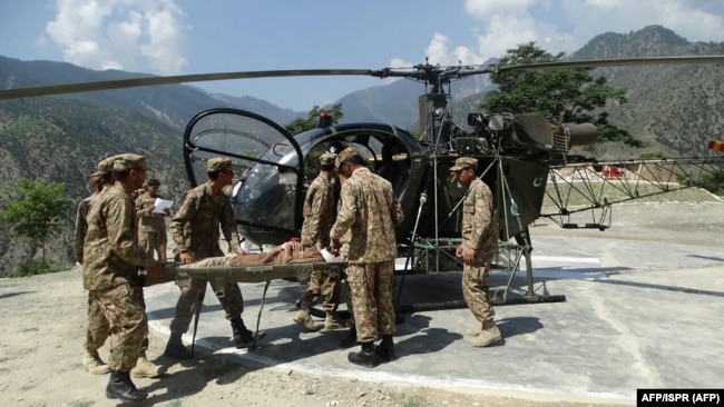 Pakistani Army personnel evacuate a resident injured in flooding in Chitral. (file photo)