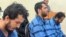 Rahmatollah Nouruzof (left), a Tajik national with admitted ties to Islamic State, sits in a courtroom with two other defendants on September 21.