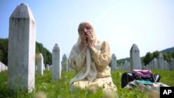 Žena tuguje u Memorijalnom centru u Potočarima gdje su ukopane žrtve genocida u Srebrenici, 11. juli 2023.