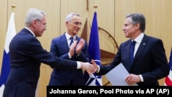 Ministar spoljnih poslova Finske Peka Havisto (levo) se rukuje sa američkim državnim sekretarom Entonijem Blinkenom (desno) nakon predaje dokumenta kojim je završen proces pristupanja Finske u NATO. Generalni sekretar NATO Jens Stoltenberg (u sredini) je pozdravio taj trenutak