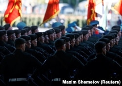 Russian service members march in columns before a military parade on Victory Day in Moscow on May 9.