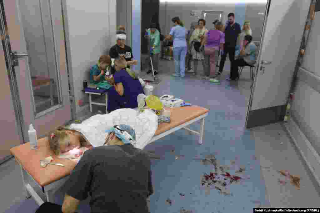 Inside the hospital, children are attended to by staff.