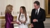 U.S. first lady Jill Biden (left) and Secretary of State Antony Blinken (right) present an International Women of Courage award to Benafsha Yaqoobi during an awards ceremony on March 4 at the White House in Washington.