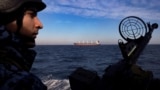 Военнослужащий береговой охраны Украины на патрульном катере во время прохода грузового судна в Черном море. 7 февраля 2024 года
