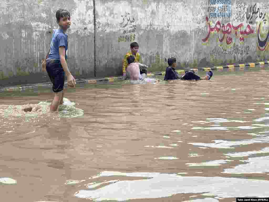 Children play in the floodwaters. Authorities said that efforts were under way to clear a key Karakorum highway in the north, blocked at various places because of landslides. Flash floods have damaged some bridges in the north, disrupting traffic.