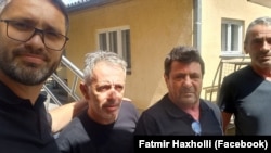 Fatmir Haxholli (left), the secretary of Kosovo's Liaison Office in Belgrade, with the three released Kosovar police officers on June 26. 