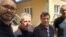 Fatmir Haxholli (left), the secretary of Kosovo's Liaison Office in Belgrade, with the three released Kosovar police officers on June 26. 