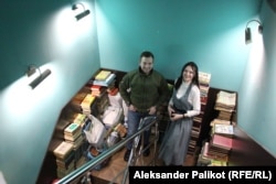 Hlib Malych, the director of Syayvo Knyhy bookstore, and Anastasia Khazova, the shop’s press officer, in front of Russian books prepared for recycling.