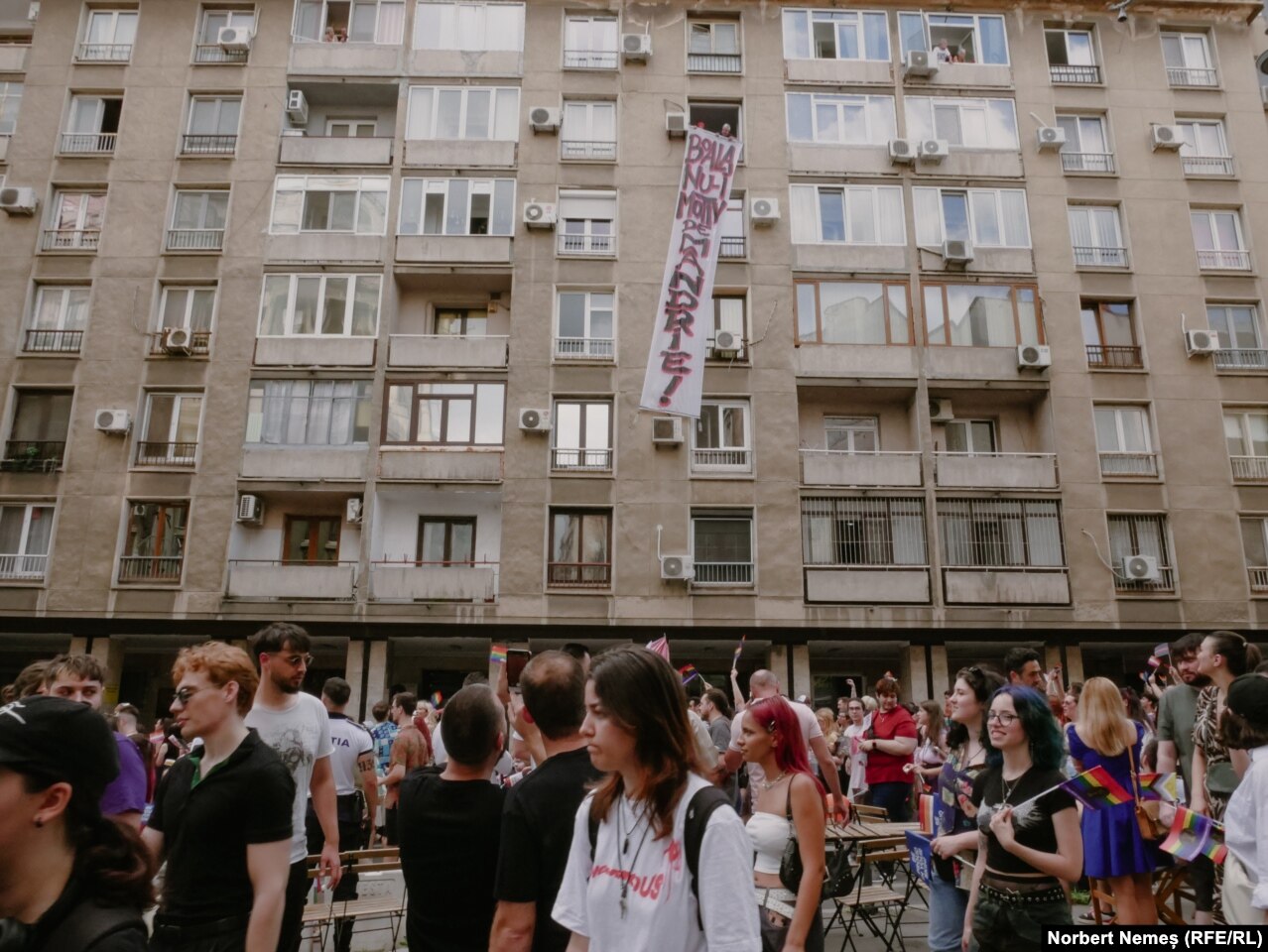 A protest banner with the slogan "Illness Is Not A Reason For Pride!" hangs from a residential area along the route. A survey commissioned by ACCEPT in 2021 showed that only 43 percent of Romanians were in favor of legal recognition of civil marriage for same-sex couples.