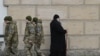 This March 14 photo shows Ukrainian soldiers passing a monk in the Kyiv Pechersk Lavra as tensions mount over a March 29 deadline for clerics to leave the property.<br />
<br />
The clergy have declared they will stay on in their historic home, as their supporters <strong><a href="https://www.france24.com/en/live-news/20230314-eviction-looms-in-kyiv-for-orthodox-monks-from-russian-linked-church">vow to back them</a></strong>&nbsp;&ldquo;whatever the cost.&rdquo;<br />
<br />
&nbsp;