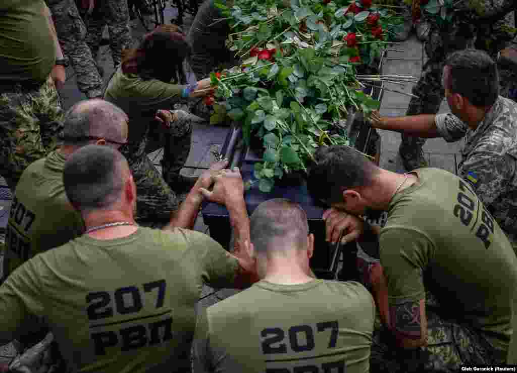 Ukrainian soldiers pay tribute to their brother-in-arms Serhiy Yarmolenko, who was killed in a fight against Russian troops in the Donetsk region, at his funeral in Kyiv.