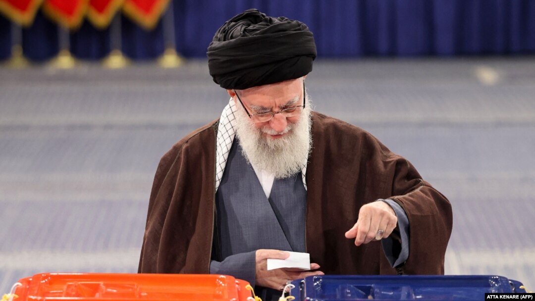 Iran's supreme leader, Ayatollah Ali Khamenei, casts his ballots during the parliamentary and key clerical body elections at a polling station in Tehran on March 1.