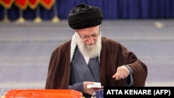 Iran's supreme leader, Ayatollah Ali Khamenei, casts his ballots during the parliamentary and key clerical body elections at a polling station in Tehran on March 1.