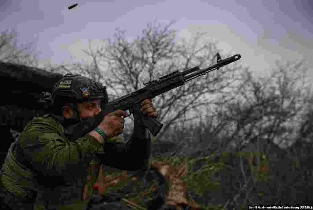 A Ukrainian soldier from the 93rd Mechanized Brigade fires an AK-74 assault rifle at Russian positions near Bakhmut on March 6. Despite artillery and equipment shortages, Kyiv&#39;s troops are fighting to slow advancing Russian troops along the almost 1,200-kilometer front. &nbsp;