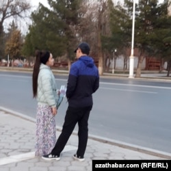 Elinde gül dessesi saklaýan gyz we oglan