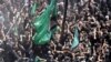 Iranian and Iraqi Shi&#39;ite Muslims re-enact the Battle of Karbala during the Ashura day ceremonies in Tehran on July 28.