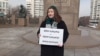 Activist Kamila Yensegen holds a single picket on Republic Square in Almaty, demanding approval of the women's march. February 14, 2024
