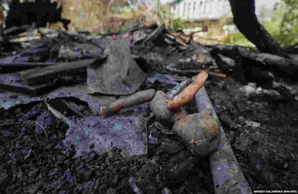 A damaged doll lies among debris at the site where a Russian drone strike hit a private building in the Ukrainian capital, Kyiv.&nbsp;