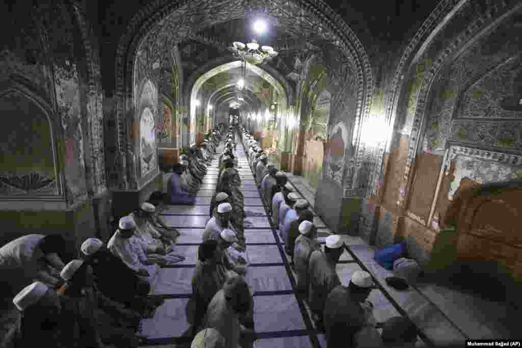 Muslim worshipers attend afternoon prayers during the holy fasting month of Ramadan at a mosque in Peshawar, Pakistan.