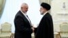 Iranian President Ebrahim Raisi (right) greets the leader of the Palestinian militant group Hamas, Ismail Haniyeh, in Tehran on June 2o.