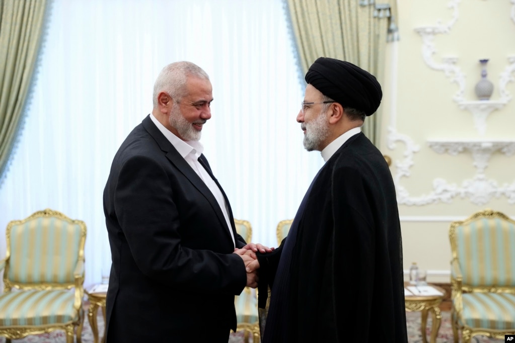 Iranian President Ebrahim Raisi (right) greets the leader of Hamas, Ismail Haniyeh, in Tehran on June 20, 2023.