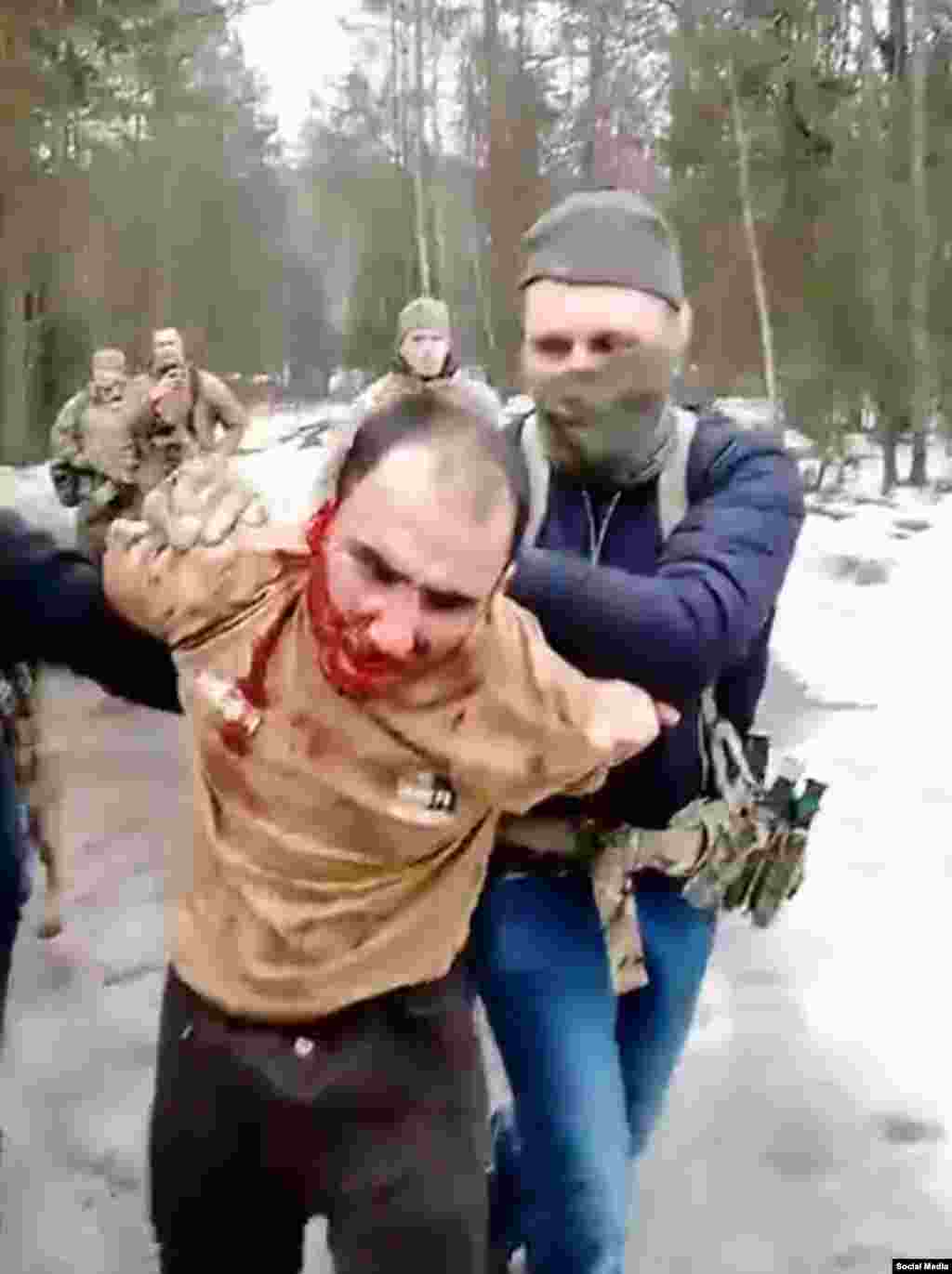 Saidakram Rajabalizoda is seen as he is led away after reportedly having his ear sliced off by uniformed men who caught him in a forest in Russia&#39;s Bryansk region on March 23. The Russian Grey Zone Telegram channel, which is connected to the Wagner group, published a video purportedly showing Rajabalizoda&rsquo;s ear being cut off and security agents trying to force him to eat it. A man in the video yells at the suspect: &ldquo;Chew, bastard! I will cut you open and shove it into your mouth.&rdquo;