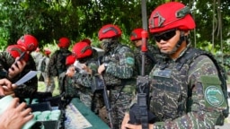 Taiwanese soldiers handle their guns during an anti-landing defense drill in New Taipei City.