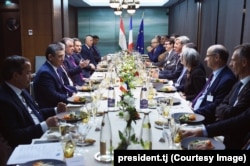 Tajik President Emomali Rahmon (left, gesturing) at a meeting of the Tajik-French Business Council in Paris on November 17, 2019. As a result of the meeting, Rahmon's daughter's company, Sifat Pharma, signed an agreement with a French partner.