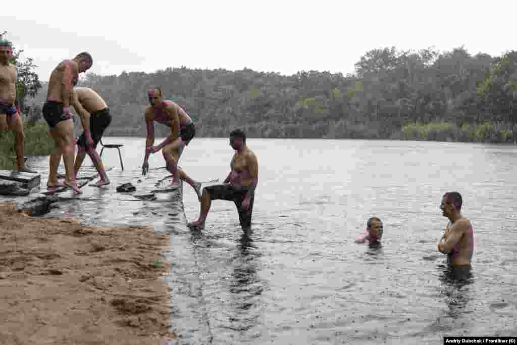 The new recruits take a swim on a Sunday, their only day for rest and recreation. Ukrainian officials have emphasized that, unlike Russia&#39;s recruitment of convicts for the notorious Wagner mercenary group, where they were thrust into the deadliest battles, Ukraine&#39;s program aims to integrate convicts into regular frontline units.