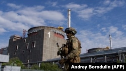 A Russian soldier patrols at the Zaporizhzhia nuclear power station in Enerhodar. (file photo) 