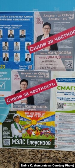 Наклейки «Сняли за честность» поверх плакатов кандидата в депутаты маслихата Алматы Жанар Джандосовой