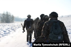 Recruits walk through the snowy hills to reach the training ground.