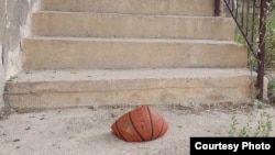 A slashed basketball lying on the doorstep of Nedim Salaharevic's family home in the village of Vlasenica. He says it is "a clear message" sent to intimidate him due to his providing testimony at war crimes trials. 