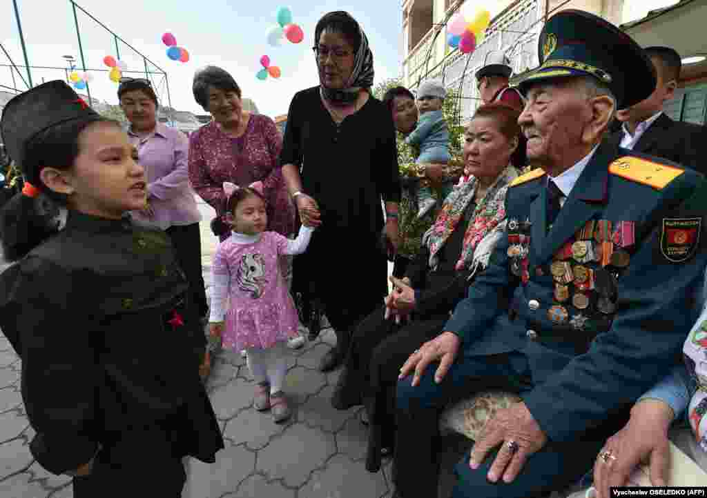 World War II veteran Asek Urmambetov, 100, receives congratulations from Kyrgyz well-wishers during Victory Day celebrations in Bishkek on May 8.